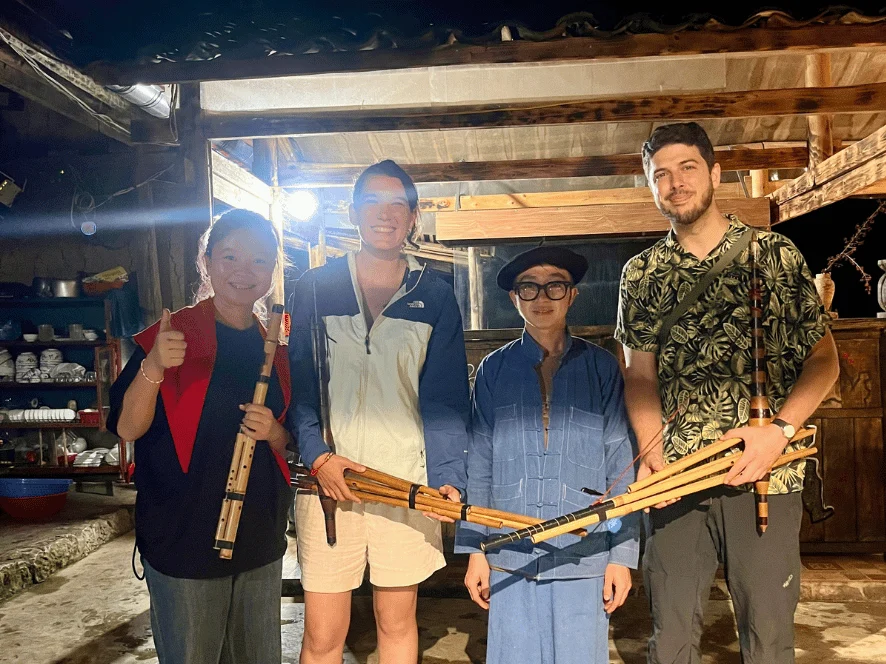 Travellers meeting a local H'Mong family on a Ha Giang jeep tour