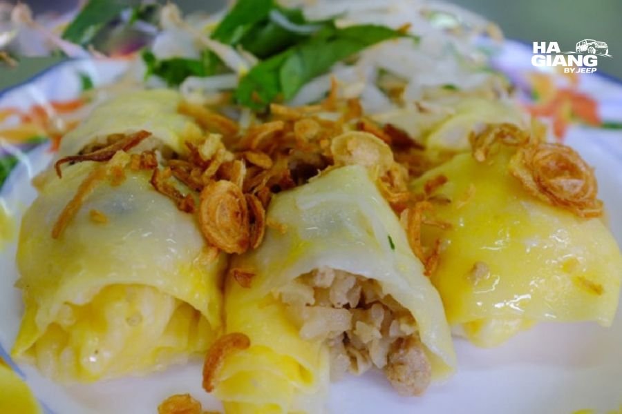 Cao Bang local food table featuring banh cuon, chao au tau, corn wine and fresh mountain herbs representing regional culinary specialties