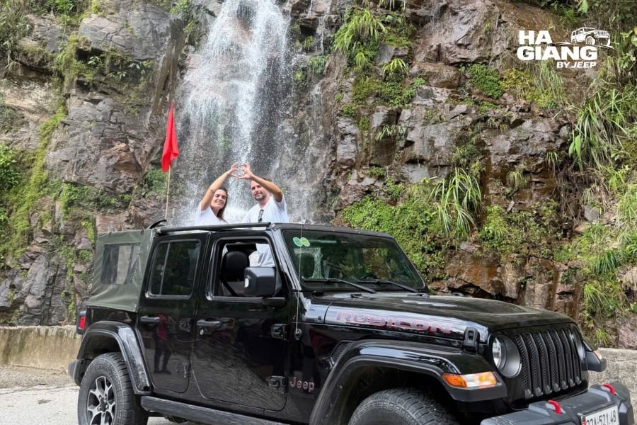 A roadside waterfall running full in the Ha Giang rainy season