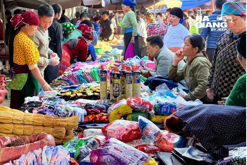 Colorful Dong Van Sunday Market with Hmong textiles and hill produce on a Ha Giang jeep tour