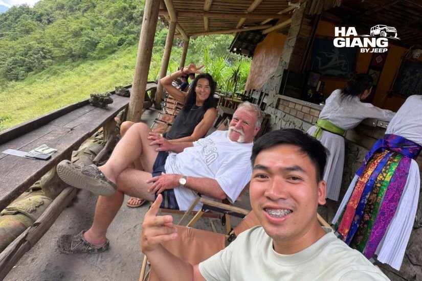 Local English speaking driver chatting with guests at a roadside stop on the Ha Giang Loop
