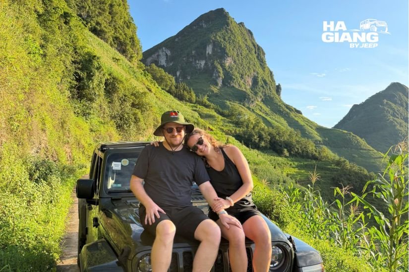 Guests relaxed in an open air jeep looking over a terraced valley in Ha Giang