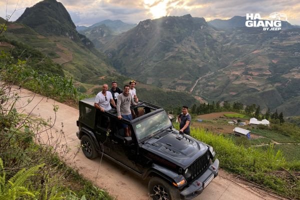 Ha Giang jeep tour what to expect: open air 4x4 parked above Ma Pi Leng Pass