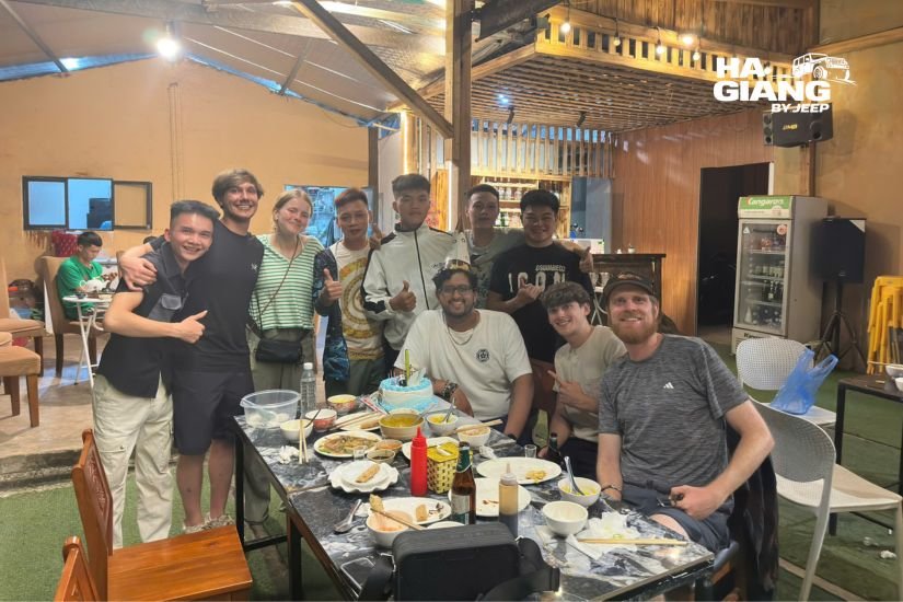 Family style Ha Giang homestay dinner spread with com lam, local dishes and corn wine