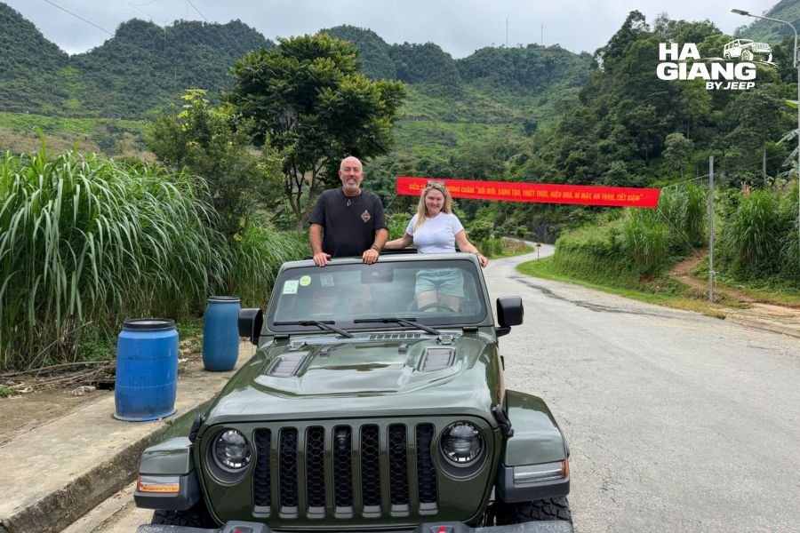 Jeep on a paved mountain pass showing good Ha Giang road conditions
