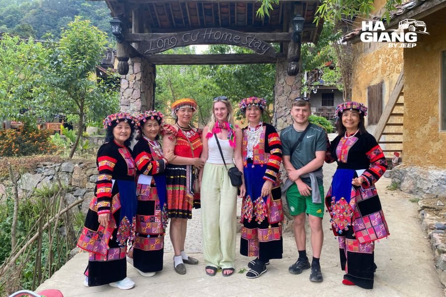 Lo Lo woman wearing traditional embroidered clothing near Lung Cu
