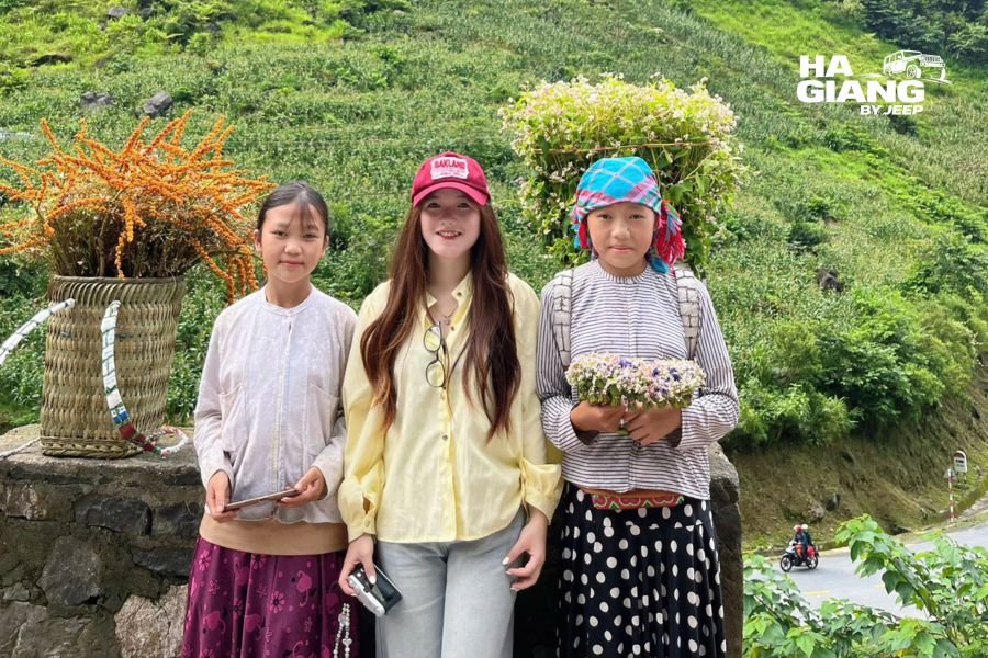 Local children in traditional dress at the Tham Ma Pass viewpoint