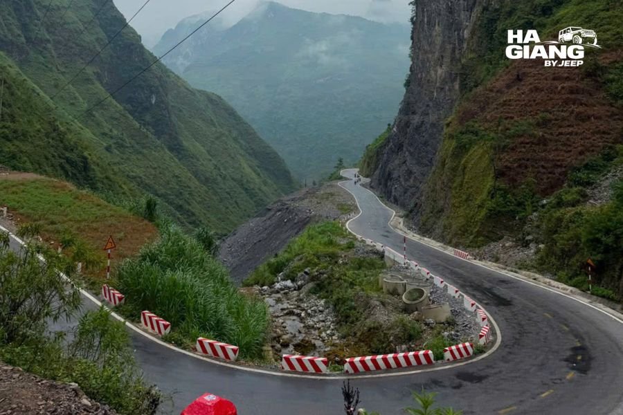 Lush green valley and empty road after rain on the Ha Giang Loop