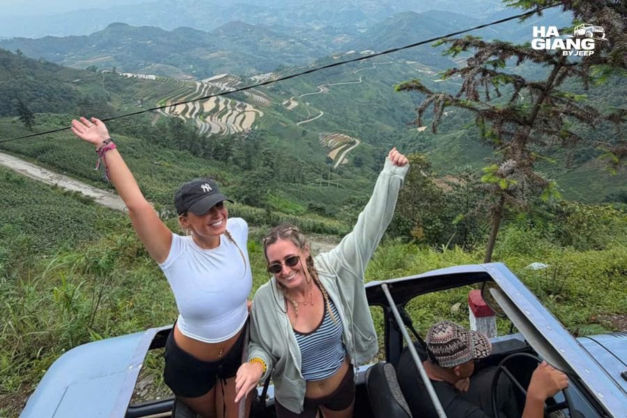 Older travelers at a viewpoint over golden rice terraces with a private jeep parked nearby