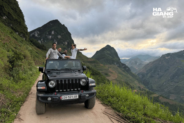 Open air jeep on a mountain road above the Tam Son valley at sunset in Quan Ba, Ha Giang