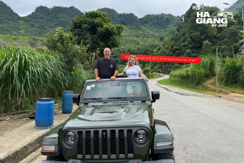 Open air jeep on a winding road through the Yen Minh pine forest in Ha Giang