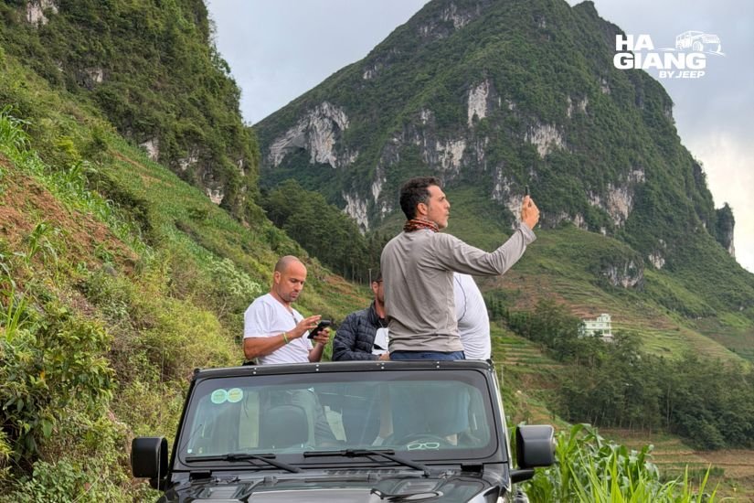 Open-air jeep parked at a Ma Pi Leng Pass viewpoint on a Ha Giang Loop 4 day itinerary