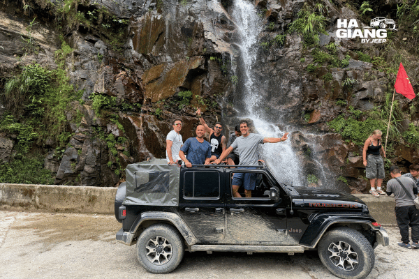 Private jeep on a quiet road between conical karst hills in Cao Bang