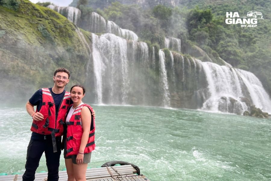 Travelers photographing Ban Gioc Waterfall from scenic spot, Ha Giang jeep tour