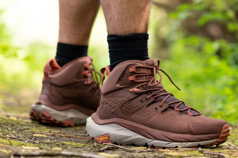 Close-up of hiking boots with aggressive tread on rocky Ha Giang mountain terrain