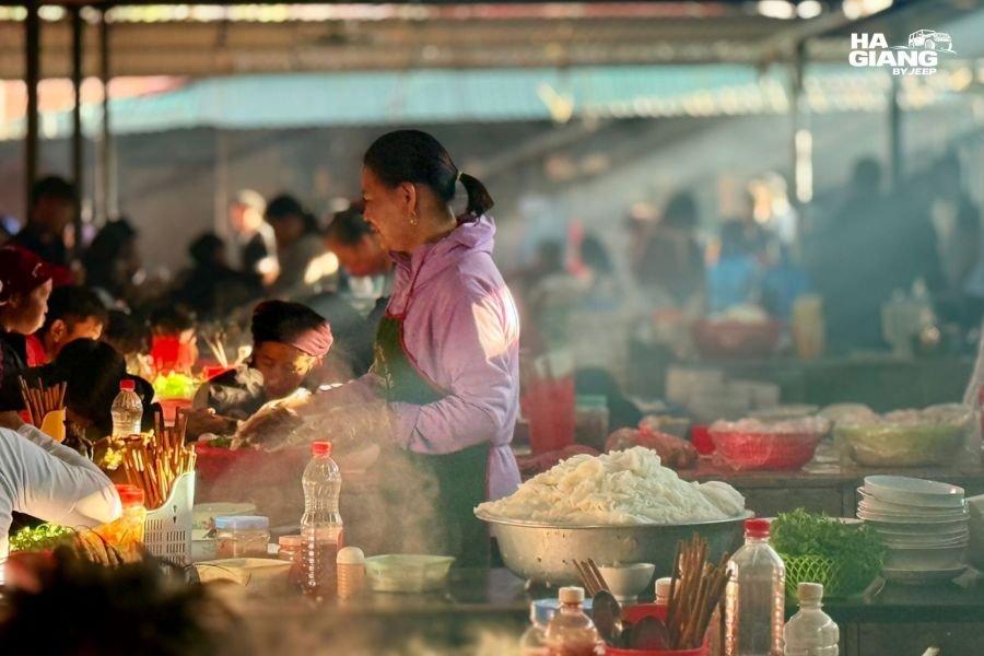Food stalls and plastic stools at a Ha Giang market