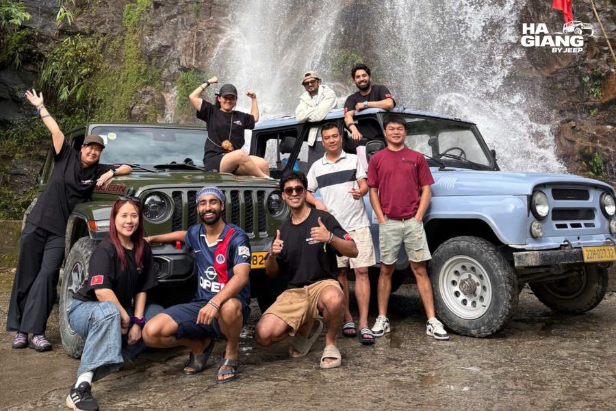 Friends standing up through the open roof of a jeep on the Ha Giang Loop