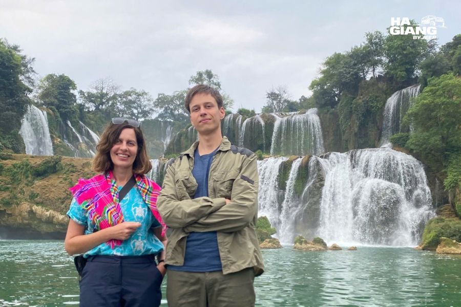 Group at Ban Gioc Waterfall in Cao Bang with bamboo rafts on the water