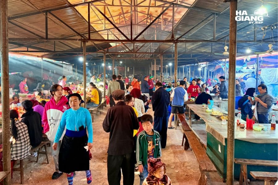 Group browsing textiles at Dong Van Sunday Market