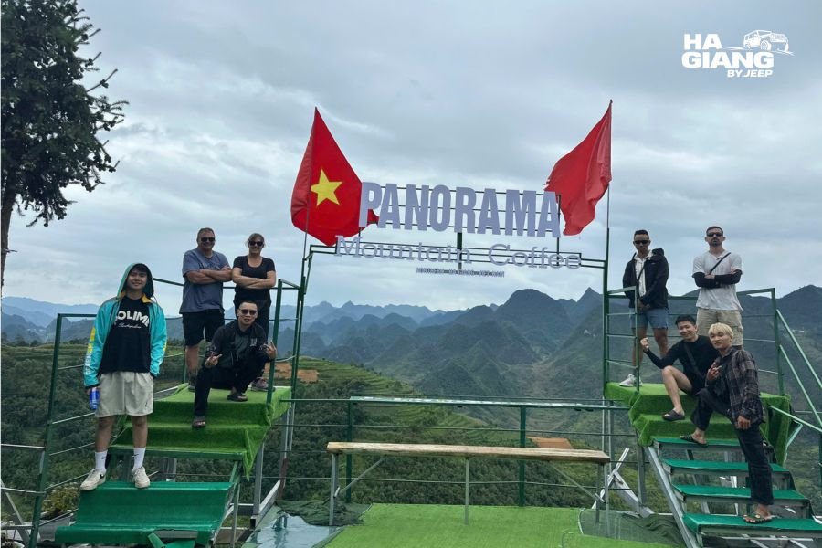 Group of travelers enjoying scenic viewpoint during Ha Giang jeep tour adventure