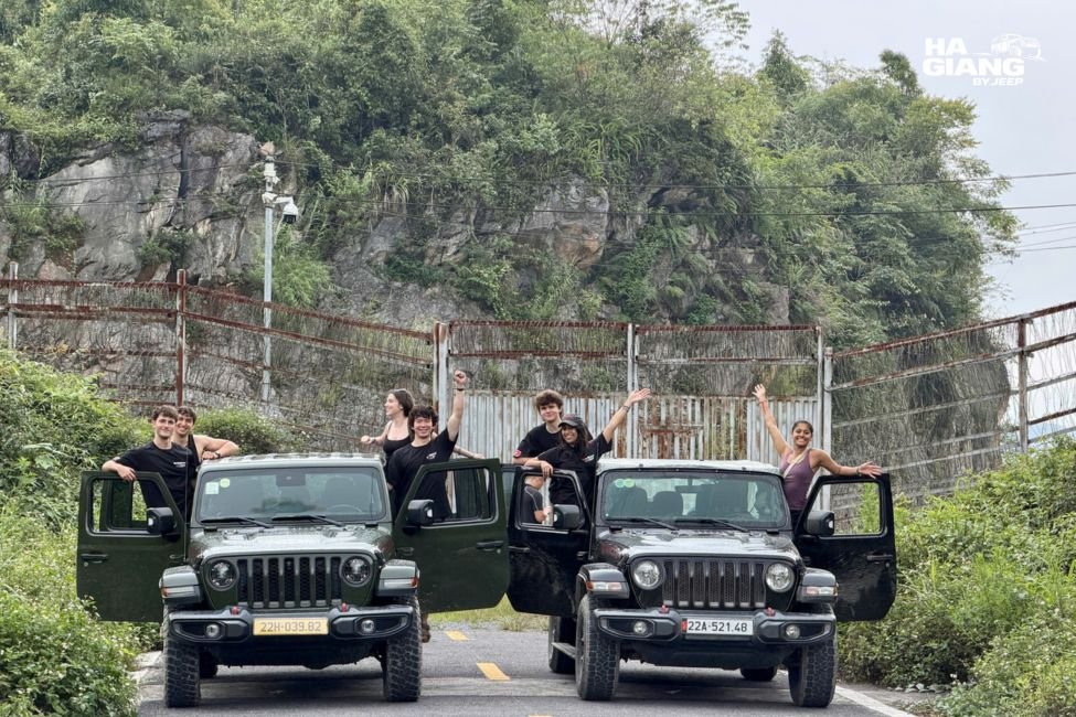 Guests with their local driver beside the jeep in Ha Giang