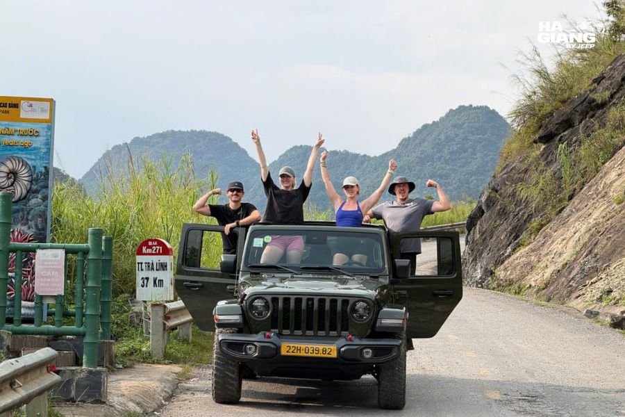 Ha Giang Loop 2026: a jeep pulled over on the loop road with the plateau ahead