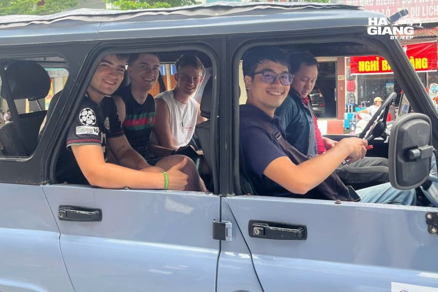 Jeep tour group gathered and prepared to depart from Hanoi hotel in early morning with travelers and vehicle ready for journey to Ha Giang