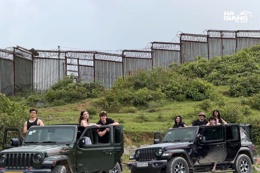 Local English speaking driver talking with guests at a viewpoint on a Ha Giang jeep tour