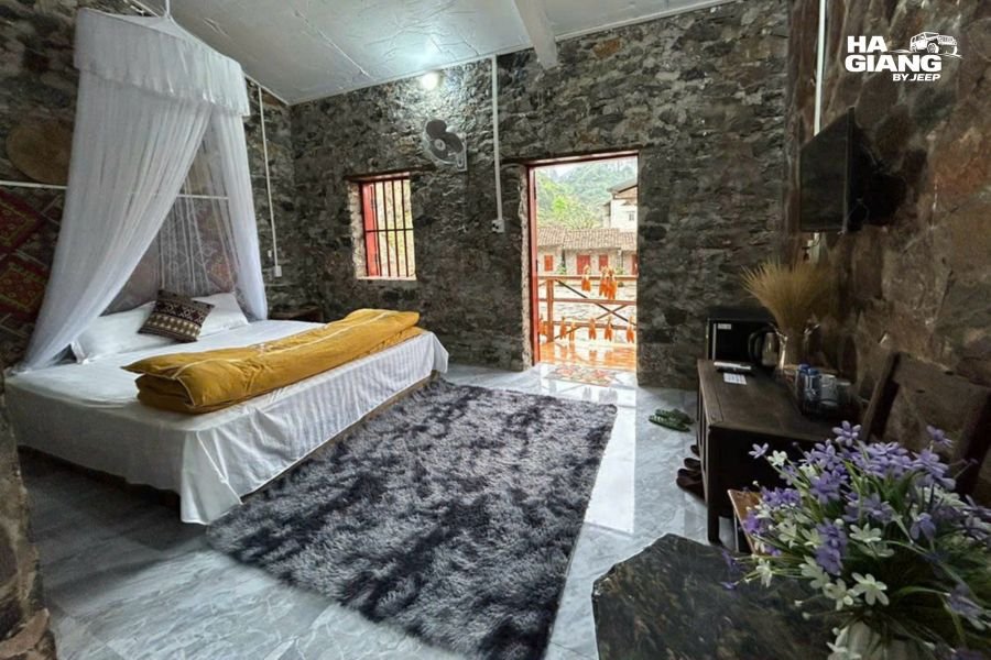 Modern Dong Van homestay room with electric heater, bathroom, and mountain view window