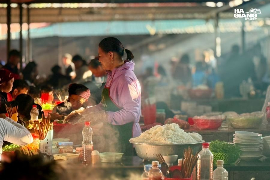 Solo female traveler exploring Dong Van Sunday Market among local vendors