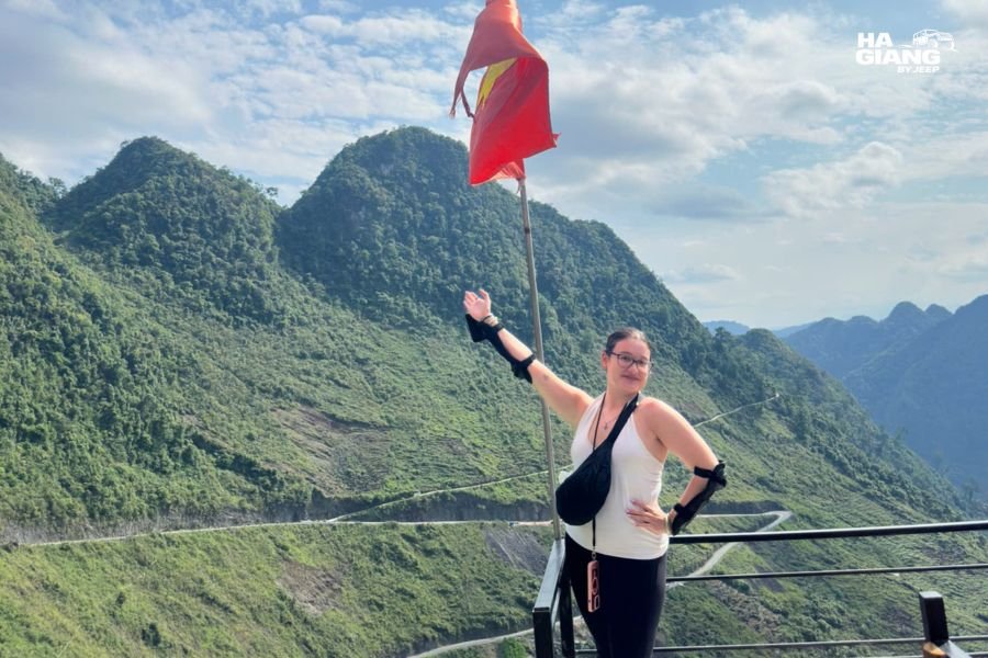 Solo female traveler hiking scenic trail near Lung Tam linen village