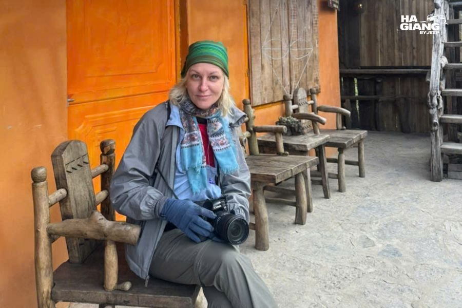 Solo woman at welcoming guesthouse in Ha Giang City, relaxed evening atmosphere
