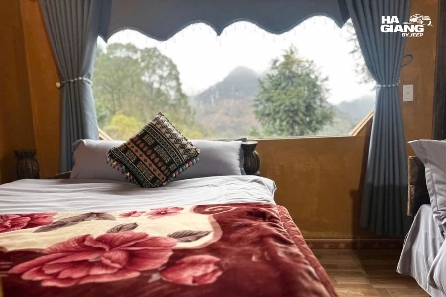 Sunrise or early morning view from homestay window showing mountain landscape and valley