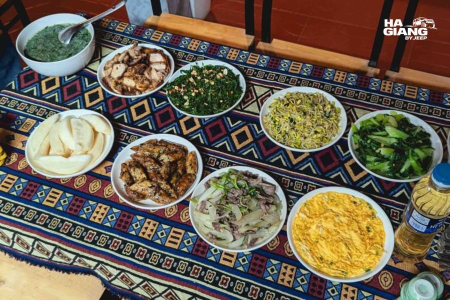 Traditional Ha Giang local dishes with rice, fresh vegetables, meat, and family meal setting at homestay restaurant