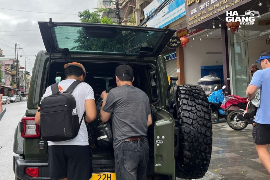 Travelers arriving fresh and energized in Ha Giang by jeep, ready to explore mountains after comfortable journey from Hanoi