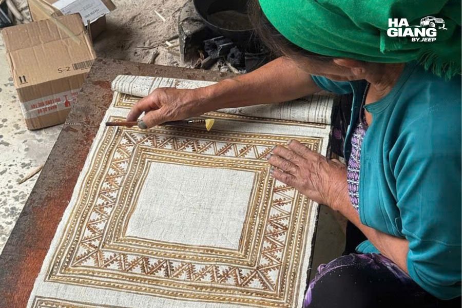 Beeswax batik being drawn freehand on hemp cloth as part of Hmong linen weaving in Ha Giang