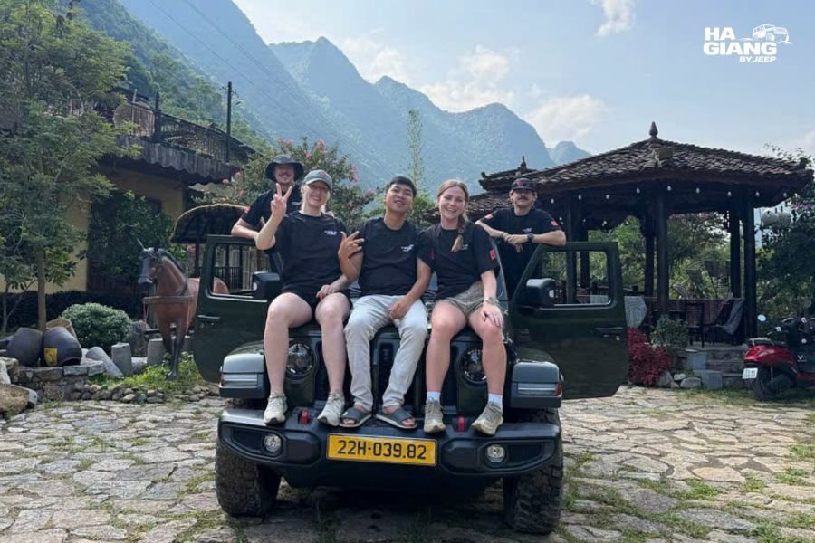 English speaking local driver and travelers beside an open air jeep on the Ha Giang Loop