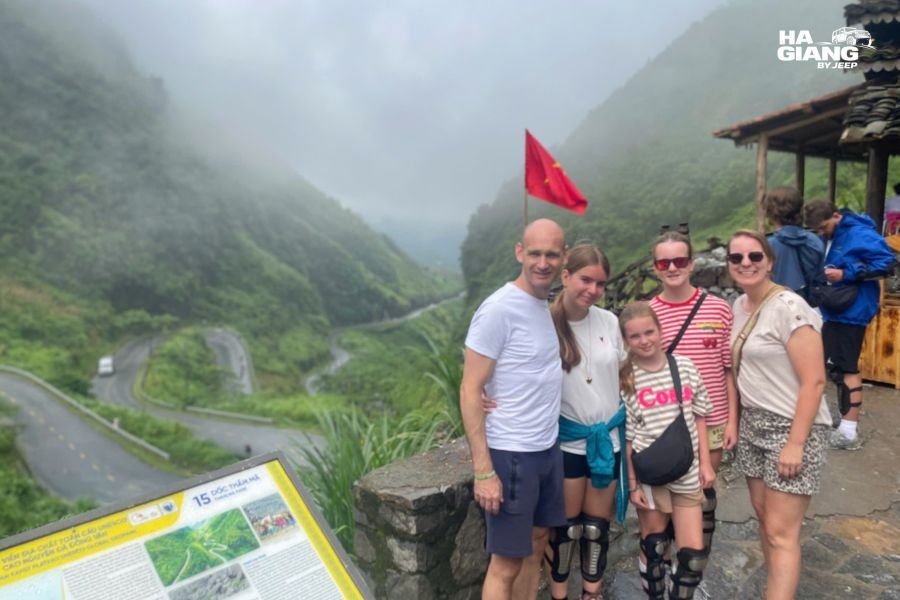 Family with young children stopping at a viewpoint on the Ha Giang Loop