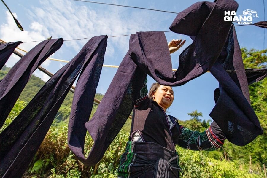 Indigo dyed hemp cloth drying outside a village house, part of Hmong linen weaving in Ha Giang