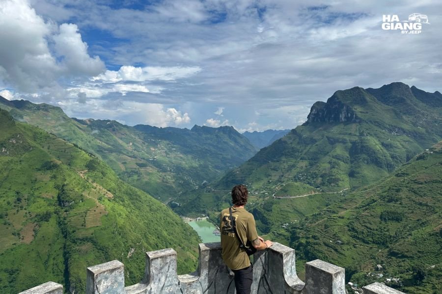Is the Ha Giang Loop worth it: travelers at a Ma Pi Leng Pass viewpoint above the Nho Que River