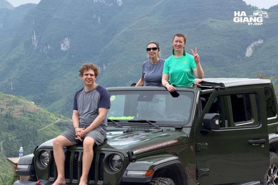 Local driver translating for travelers at a viewpoint during a Ha Giang jeep tour