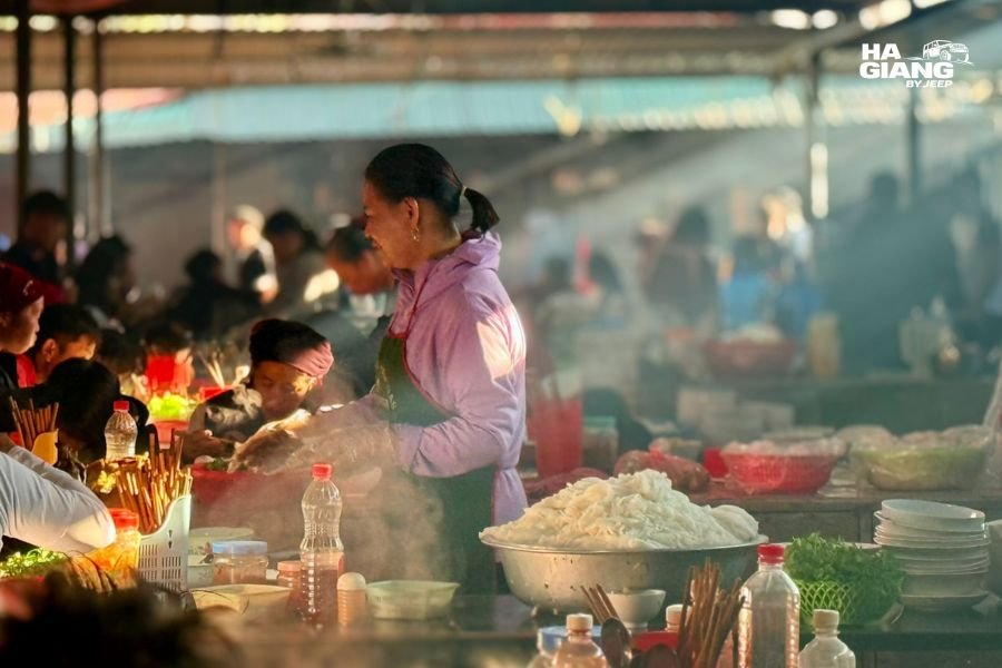 Market stall at Dong Van Sunday Market in Ha Giang where travelers spend cash on textiles and food