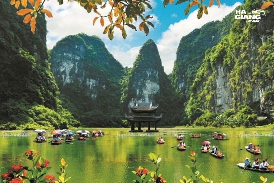 Rowing boats among limestone karst at Tam Coc, Ninh Binh
