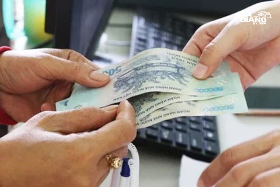 Traveler paying with Vietnamese dong at a market stall in Dong Van after using a Ha Giang ATM