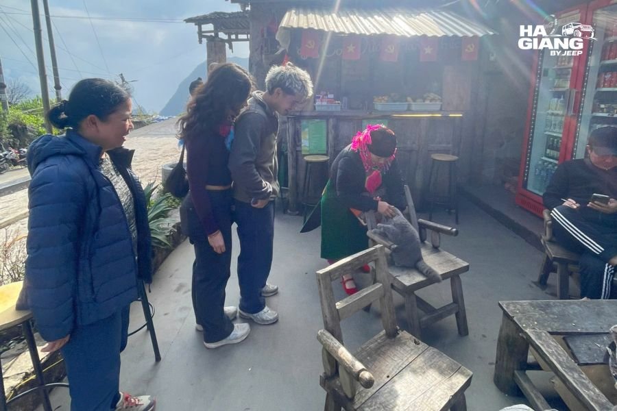 Traveler using Vietnamese greetings with an older woman in a Ha Giang village