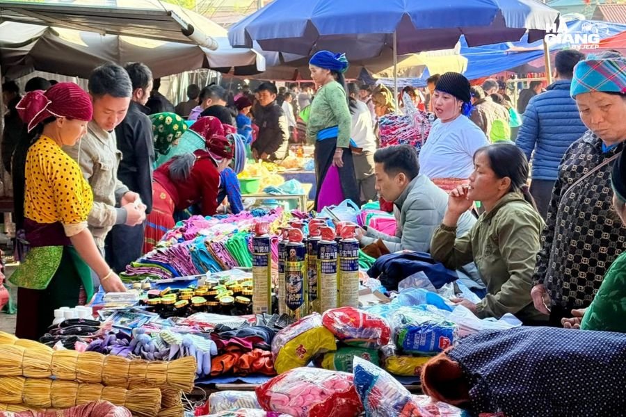 Travelers exploring a highland market with their local driver in Ha Giang