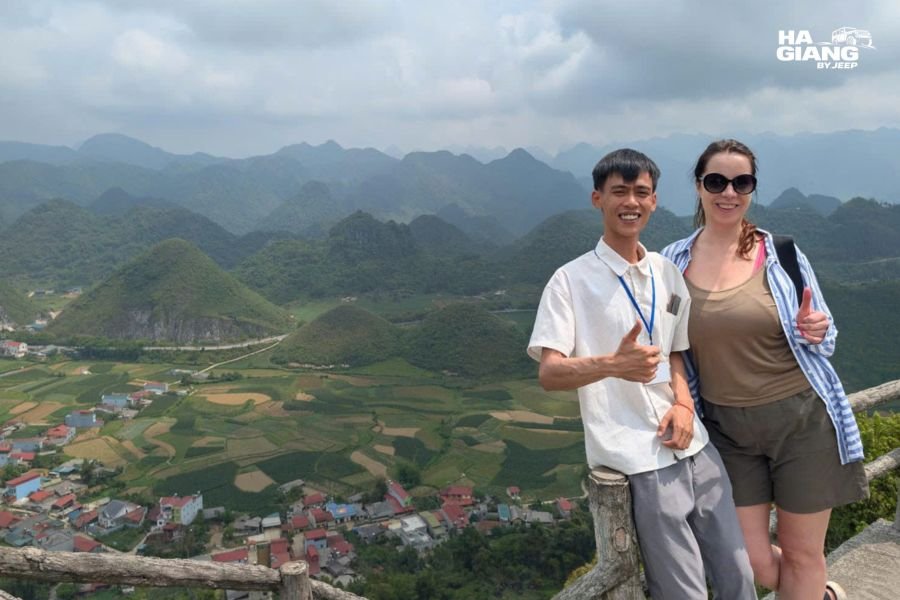 Travelers in layers against the wind at a Ha Giang mountain viewpoint