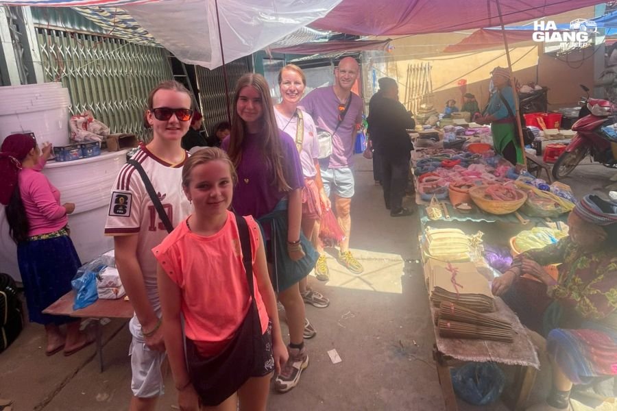 Travelers stopping at a highland market in Ha Giang with their private jeep