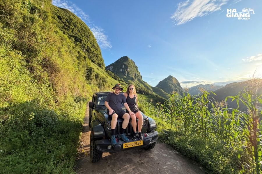 A couple in a private jeep on the Ha Giang Loop at a mountain pass
