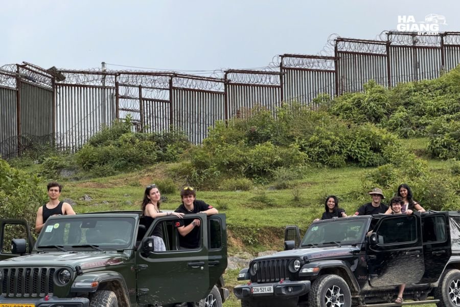 Ha Giang jeep tour: open-top Jeep Wrangler Rubicon on the plateau with mountain valley below